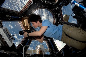 European Space Agency (ESA) astronaut Samantha Cristoforetti, a Flight Engineer with Expedition 42, photographs the Earth through a window in the Cupola on the International Space Station.